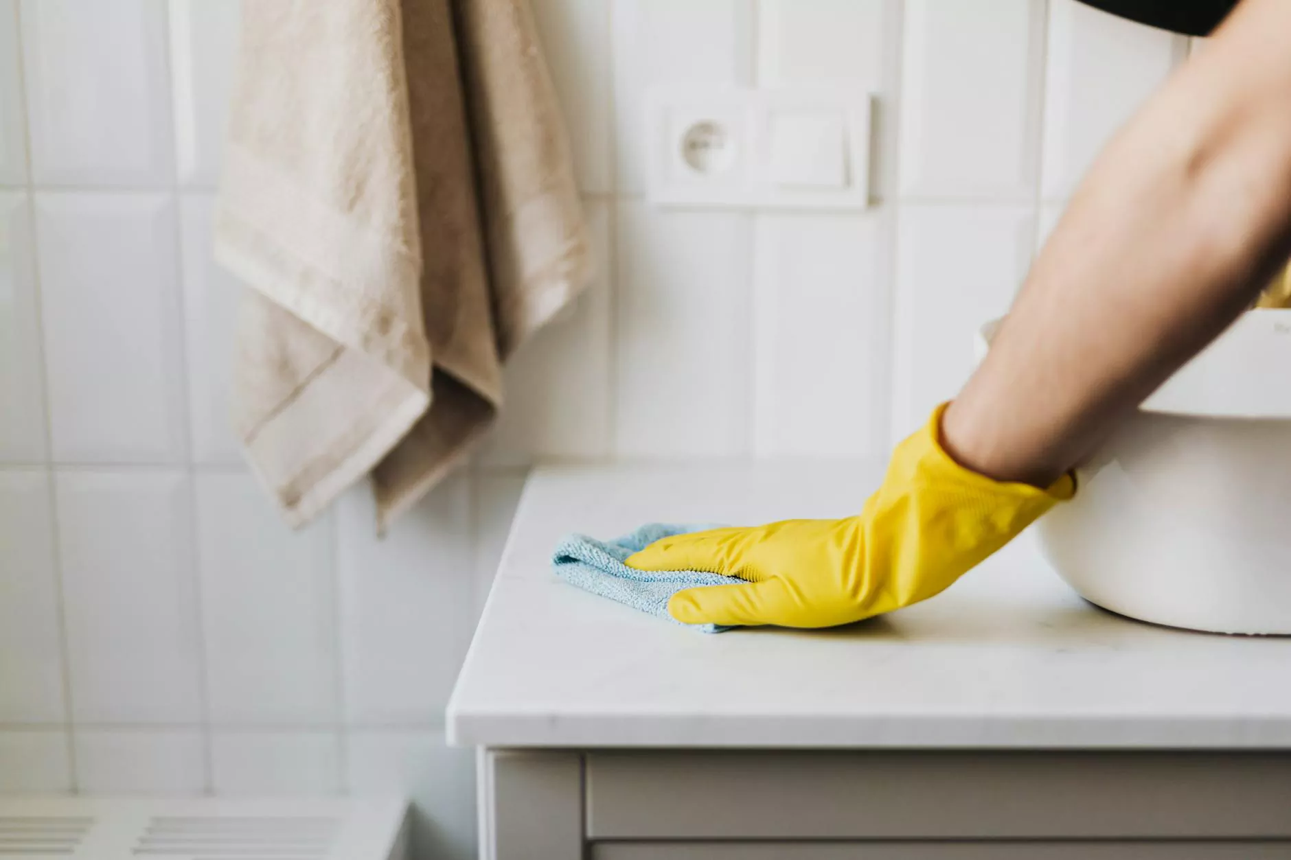 Illustrative detail of a bathroom surface being wiped